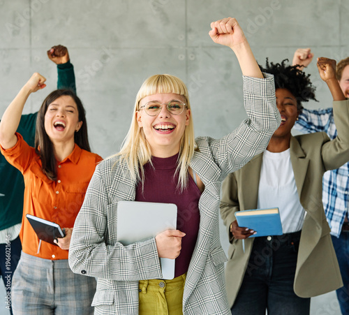 Portrait of a group of young happy business people having fun and celebrating during a meeting in the office. Teamwork, unity, diversity and success concept