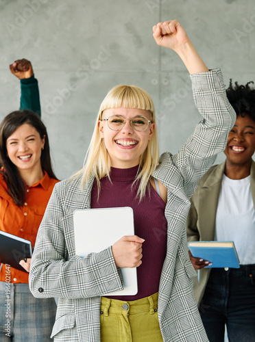 Portrait of a group of young happy business people having fun and celebrating during a meeting in the office. Teamwork, unity, diversity and success concept
