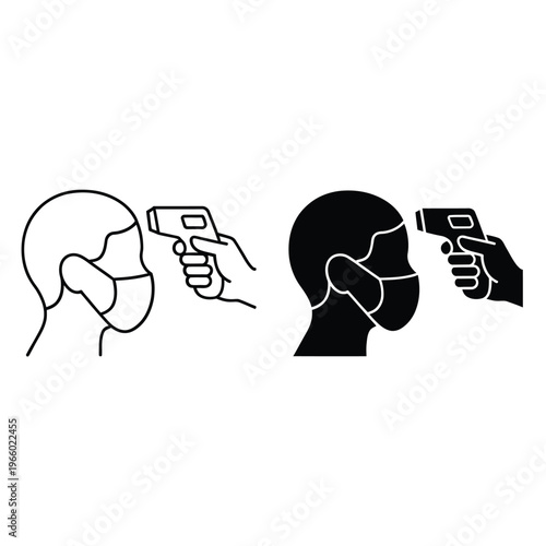 Infrared thermometer scanning a person s forehead with protective face mask