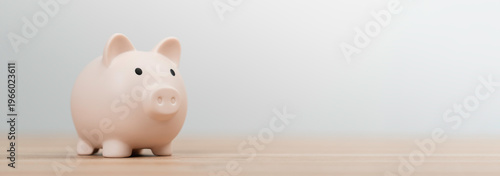 Financial saving, save money concept. Pink piggy bank on wooden table white background, for future investment, money management, and banking budget for personal wealth or retirement planning.