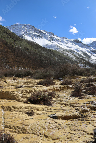 Crystal clear water flowing down from melting snow mixed with limestone water from underground at Huanglong National Park, Songpan County, Sichuan Province of China