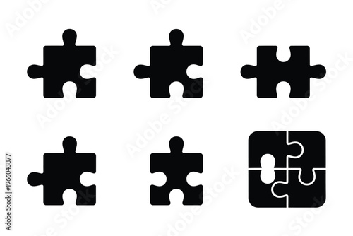 A collection of black puzzle pieces some separated and one fully assembled on a white background