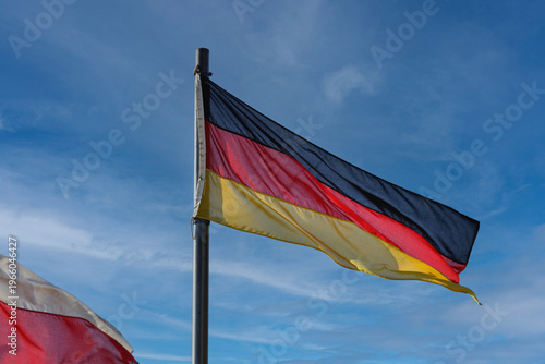 Federal Republic of Germany Flag at Flagpole Blue Sky