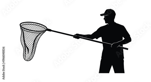 A lone fisherman stands poised with a large landing net ready to scoop a catch presented as a silhouette high quality