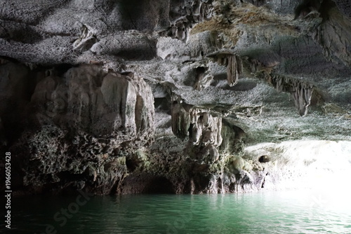 Inside one of the numerous cave with stalactites and stalagmites in Vietnam by the river