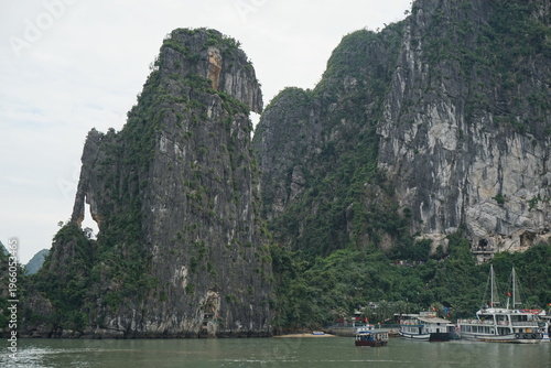 amazing rock formation in halong bay vietnam with several boats