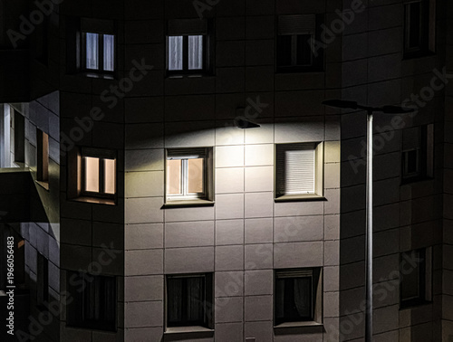 Night Building Exterior with Illuminated Windows in Urban Setting