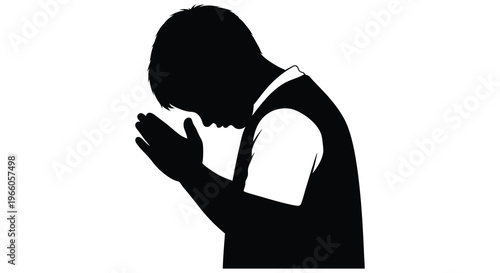A young person with head bowed in a prayerful pose hands clasped together presented as a stark silhouette high quality professional