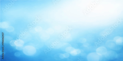 Abstract blue bokeh background featuring bright sunlight and fluffy white clouds in a beautiful clear summer sky