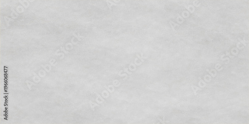 A high resolution neutral grey concrete texture background with a soft and subtle grainy surface