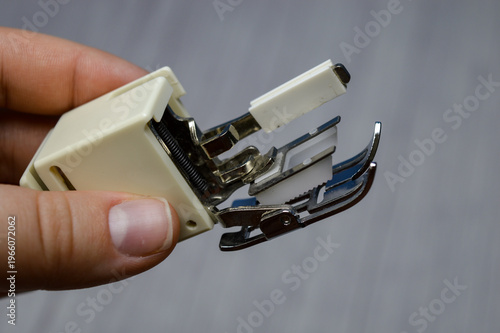 Cuadro en lienzo hand holding sewing machine presser foot attachment