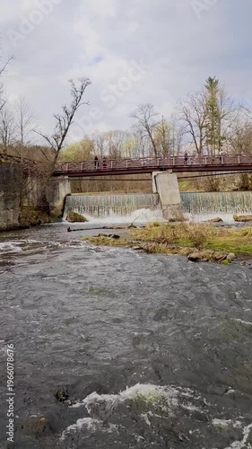 Scenic view of Belmont Falls in Vilnius, Lithuania, cascading waterfall surrounded by lush greenery, natural landscape. French built a flour mill. 4K vertical video footage