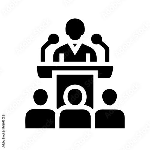 A black silhouette of a speaker at a podium with audience