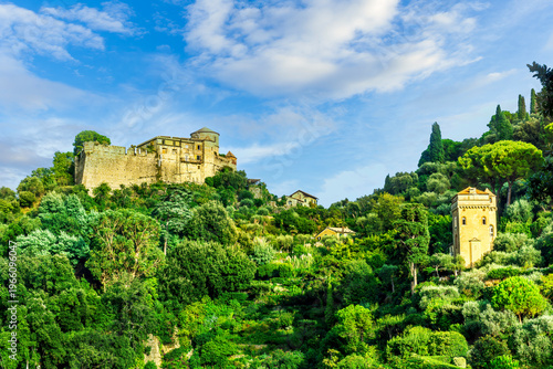 beautiful landscape of famous italiat resort Portofino in Luguria with ancient houses and buildings of hotels and restaulants along the embarkment of a sea gulf with sunset golden light
