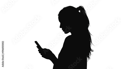 Silhouette of a young woman looking intently down at a small handheld communication device on a white.