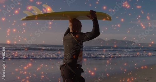 Spark overlay appearing surfer walking shore holding yellow board aloft preparing entry into surf