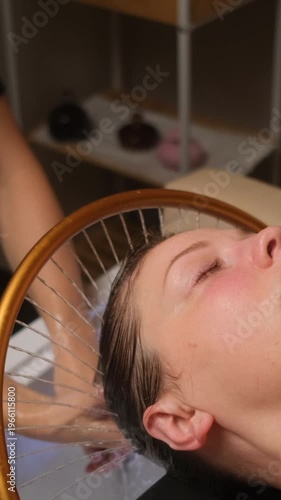 Caucasian woman enjoying a relaxing head massage and hair washing procedure in a beauty salon