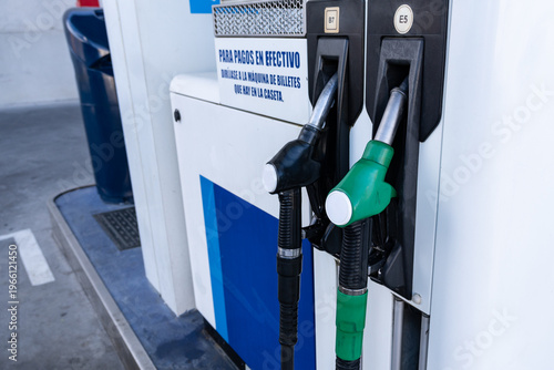 Konstfotografi Fuel pump with two nozzles at gas station, close-up detail.