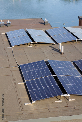 Solar panels on roof of apartment housing building with Gothenburg city center in background, Sweden, renewable green sustainable energy concept
