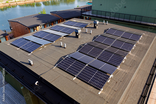 Solar panels on roof of apartment housing building with Gothenburg city center in background, Sweden, renewable green sustainable energy concept