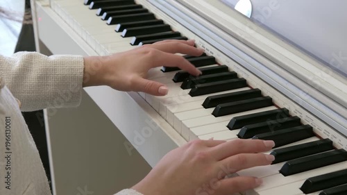 Female hands playing the piano
