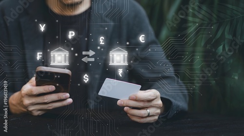 Hands holding smartphone and credit card with digital real estate investment hologram overlay