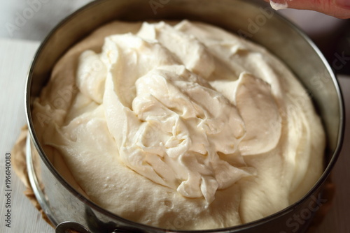Transfer cheese filling into baking pan. Making frozen strawberry cheesecake series.