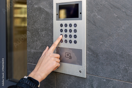 Tableau sur toile Hand pressing keypad on video intercom panel