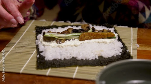 Fried tempeh stripes added to homemade sushi roll with mushrooms and fresh cheese horizontal