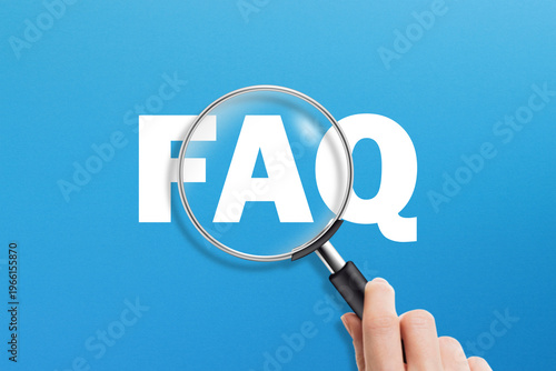 FAQ and magnifying glass on blue background. Frequently asked questions.