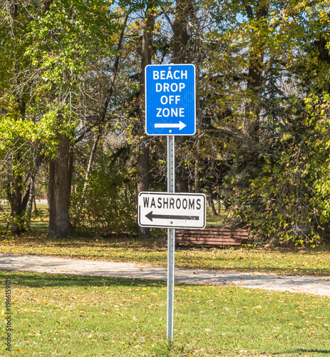 A beach and washroom signs in Winnipeg Beach, Manitoba, Canada on a sunny fall day