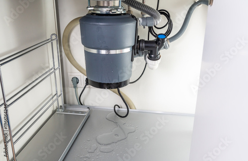 Bild auf Leinwand Waste disposal leak under a sink, broken garbage chopper