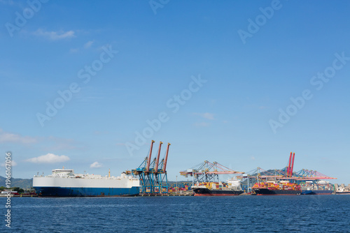 Container ships and cargo terminal with cranes and copy space