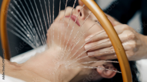 Hydro facial spa treatment, smooth water flow generated by modern massage device.
