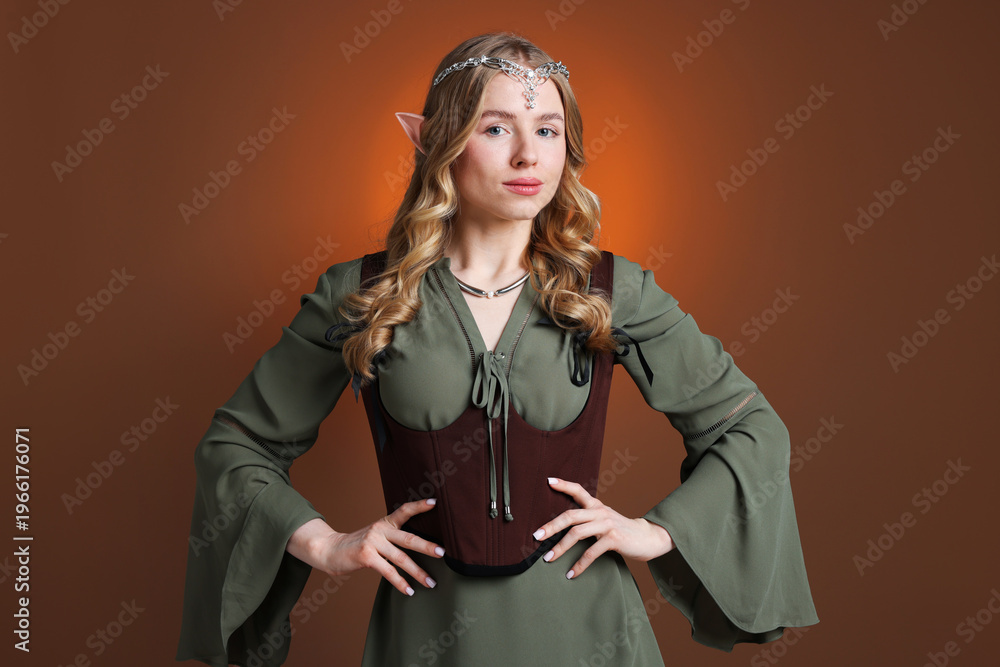 Obraz premium Portrait of beautiful elf girl on brown gradient background