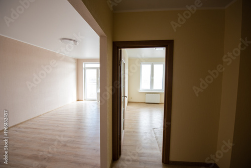 Interior view of empty apartment with wooden flooring and natural light