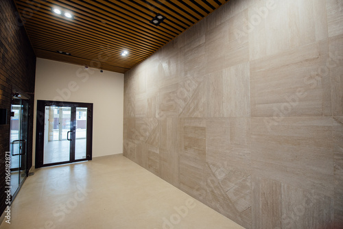 Modern interior space with wooden ceiling and tiled wall design