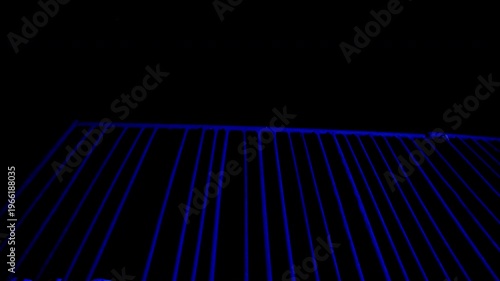 Nighttime fence scene. Flashes of light like sirens illuminate metal bars. Moody, cinematic urban atmosphere. Dark, dramatic, tense motion footage for storytelling.