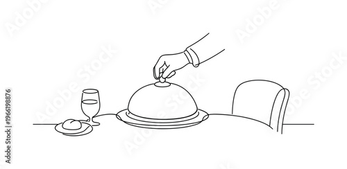 Waiter’s hand placing a covered cloche onto a neatly set table, water glass and bread plate already arranged, chair slightly