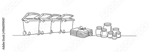 Row of large outdoor recycling containers with hinged lids slightly open, stack of sorted newspapers tied with string placed