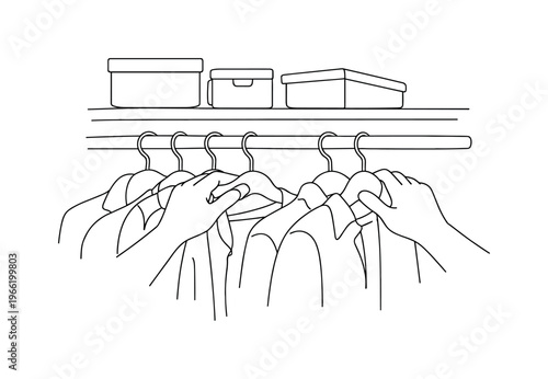 Close view of hands sliding hangers along a clothing rack, mix of jackets and shirts visible, small storage boxes arranged on the