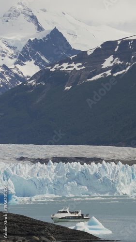 Panoramic view of Perito Moreno Glacier with a tour boat and mountains in nature