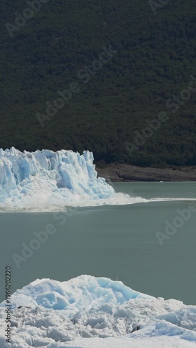 Large ice chunk falling from the Perito Moreno Glacier into the water in nature