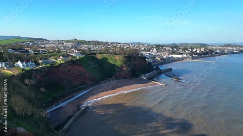 Dawlish, Devon, England: DRONE VIEWS: An intercity train passes through a cliff tunnel on its way towards Dawlish railway station. Dawlish is a popular UK tourist destination on the mainline railway. 
