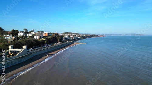 Dawlish, Devon, England: DRONE VIEW: An intercity train passes through Dawlish railway station on the seafront. Dawlish is a popular UK tourist destination on the mainline railway to London Paddington