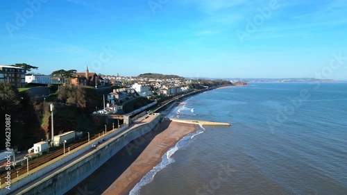 Dawlish, Devon, England: DRONE VIEW: An intercity train heads for Exeter along the Dawlish seafront. Dawlish is a popular UK tourist destination on the mainline railway to London Paddington. 