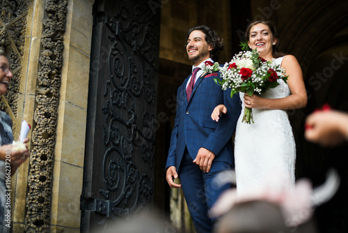 Φωτογραφία Joyful newlyweds exiting church.
