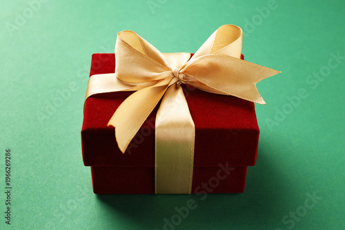 Beautiful velvet gift box on green background, closeup