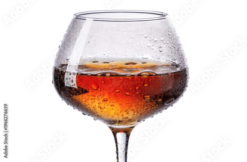 Glass with amber liquid cognac in glass warm evening mood

