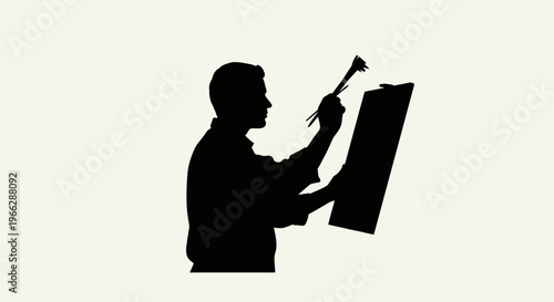 Silhouette of man painting on canvas.